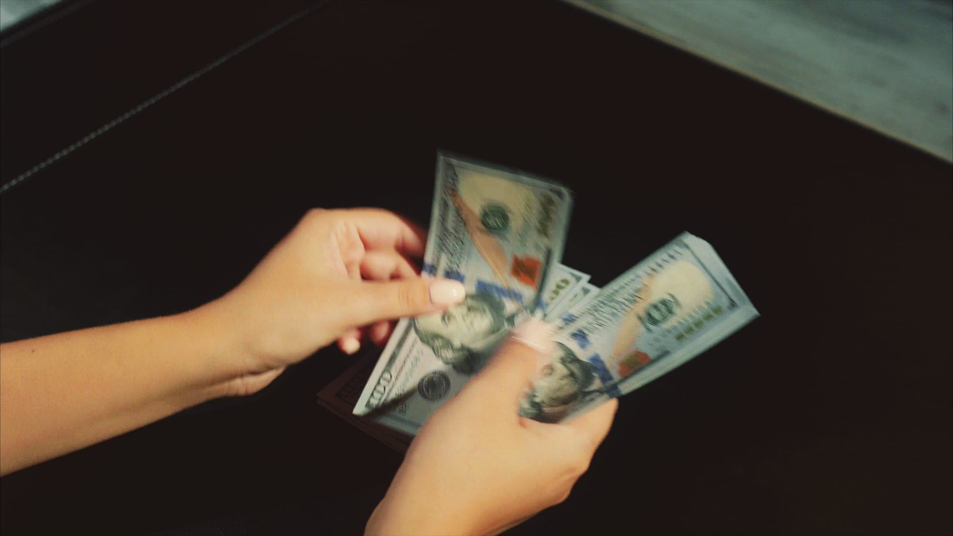 Hands counting cash for emergency savings