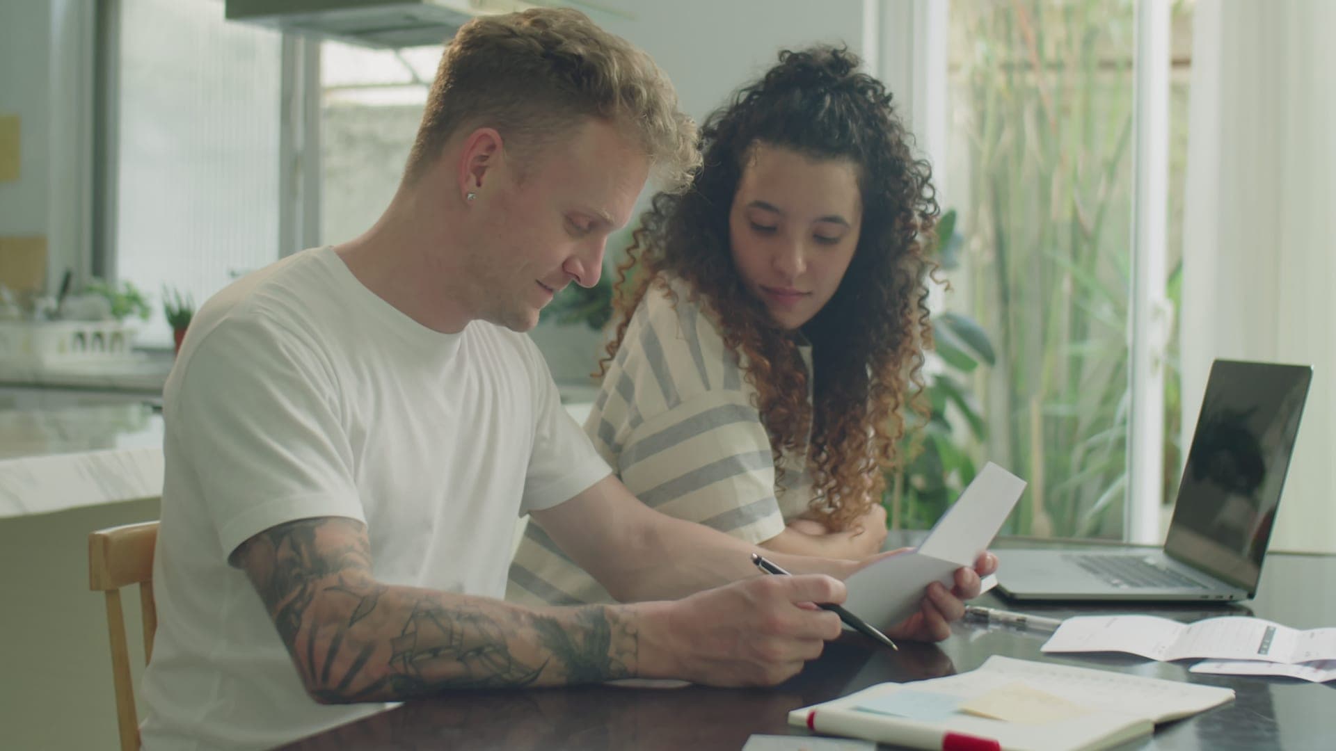 A couple reviewing bills and debt paperwork together.