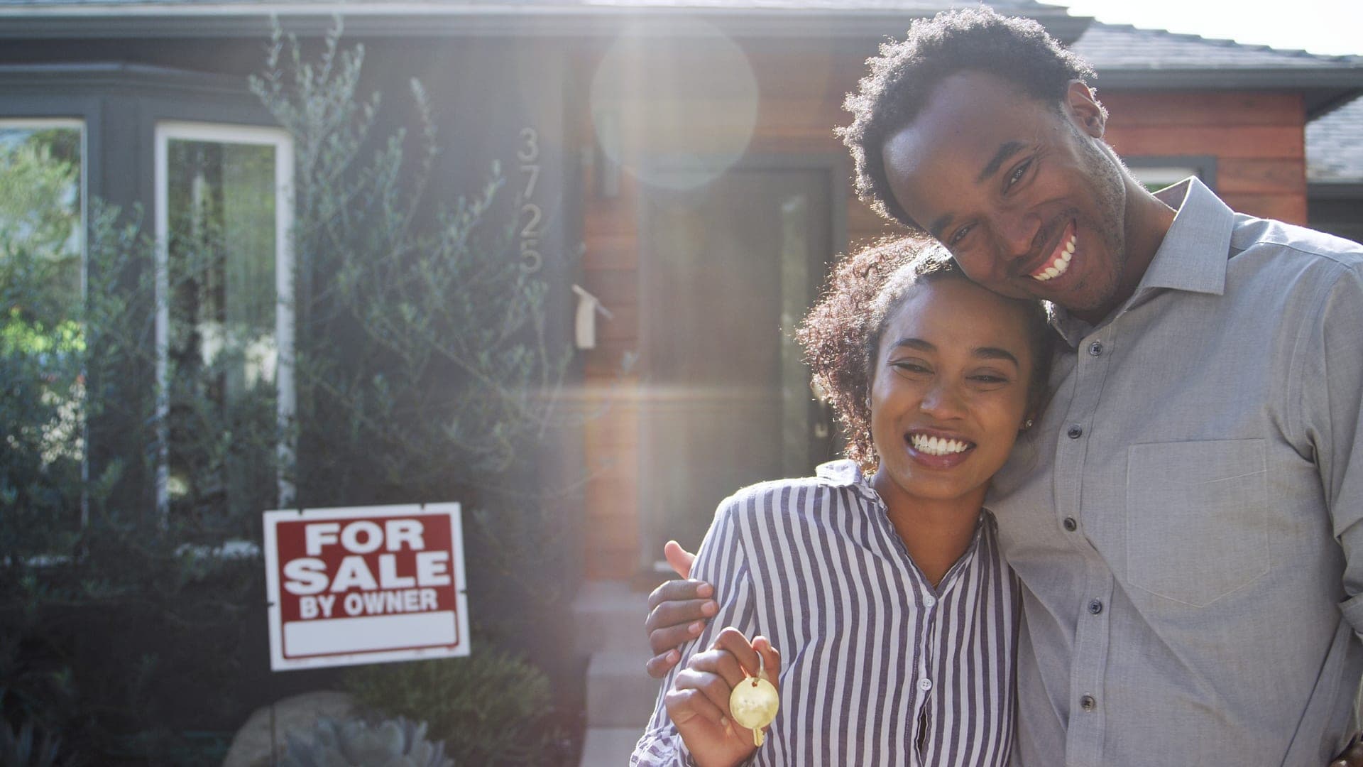 Couple in front of house for sale