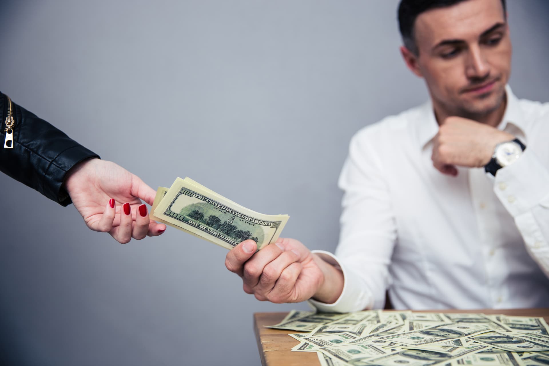 Person handing over money, representing common money mistakes