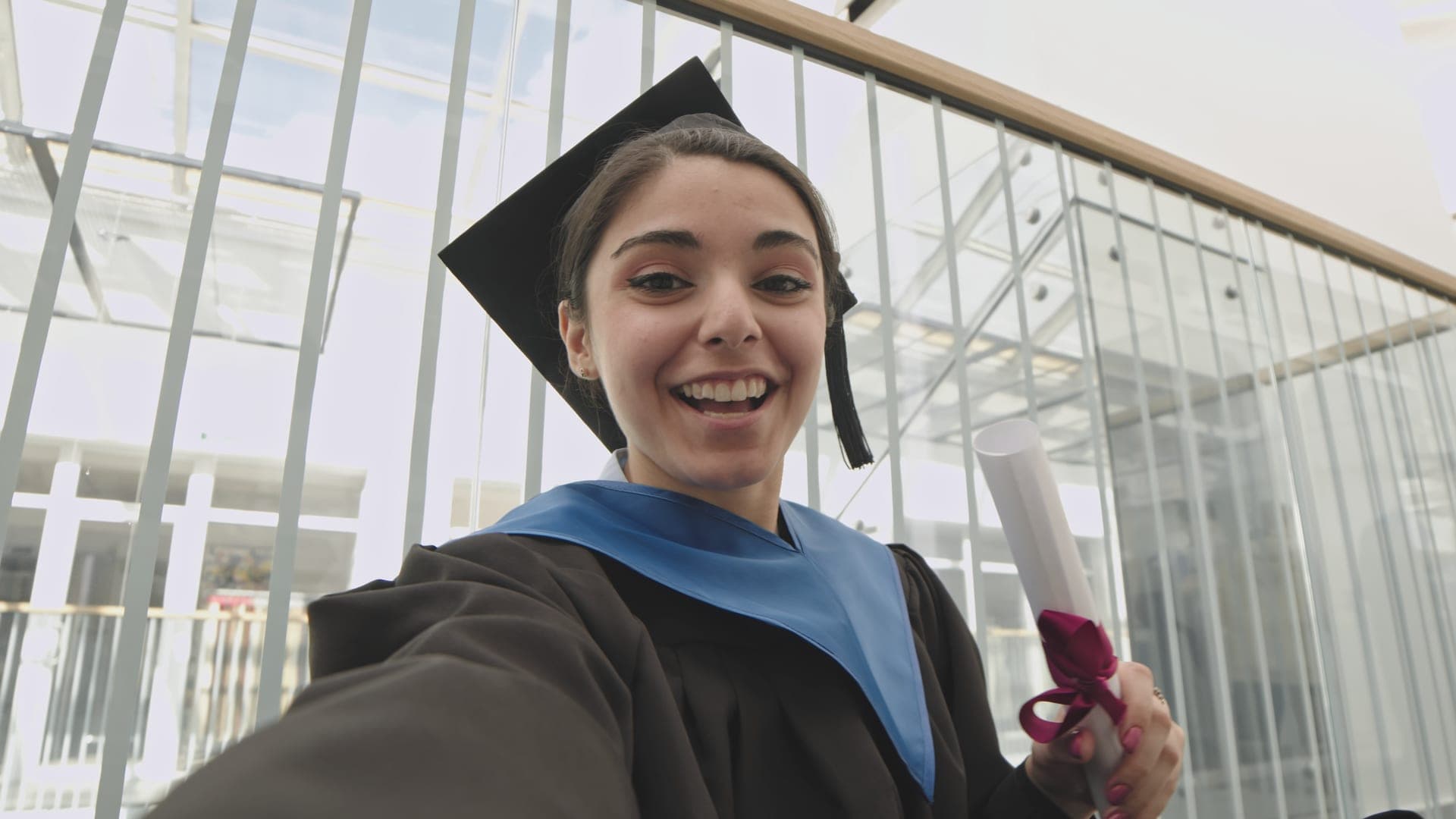 Happy graduate holding diploma, ready for career