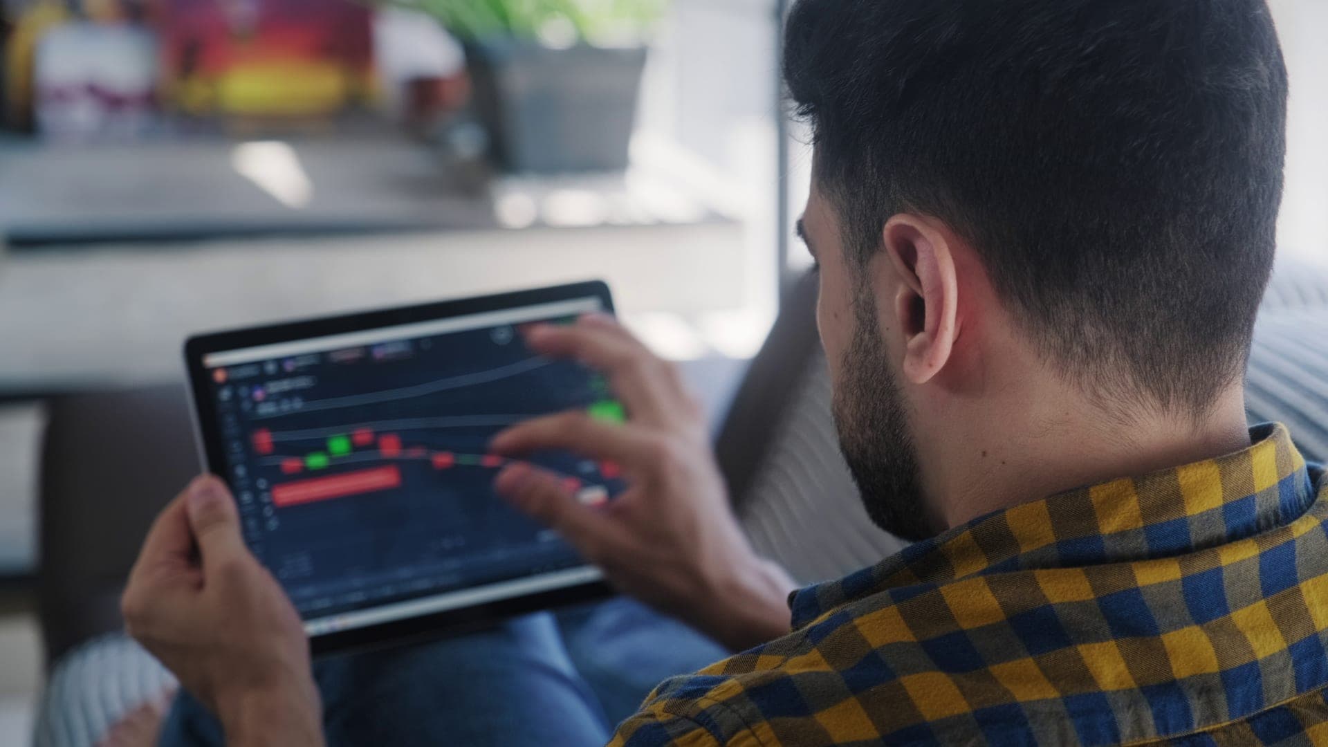 A tablet displaying market charts for investment research