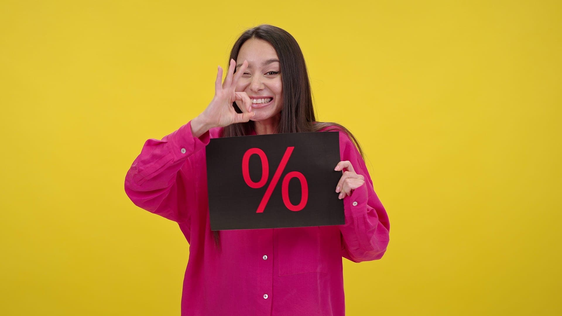Woman holding a percent sign to represent investment fees