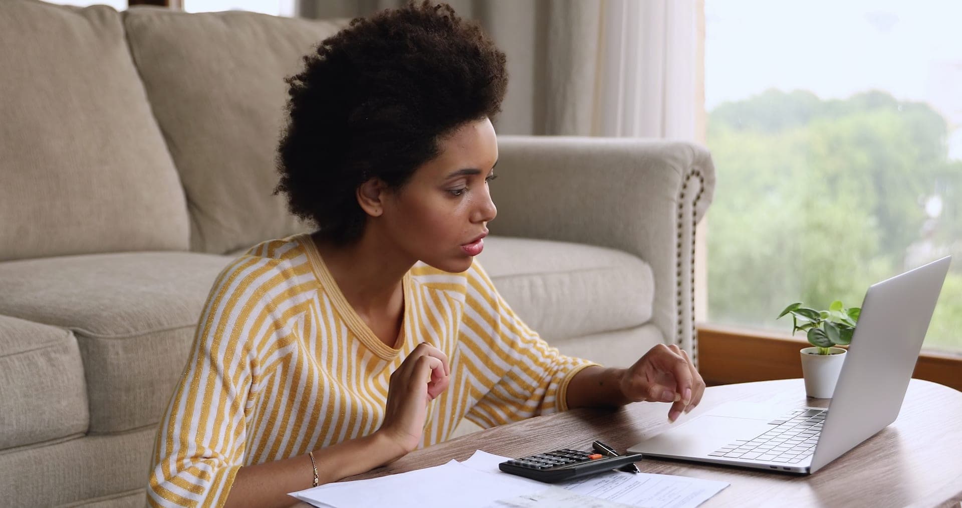 Woman calculating utility bills and finances